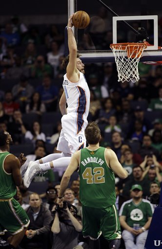 Charlotte Bobcats' Josh McRoberts grabs a high pass for a dunk against the Boston Celtics during the second half of an NBA basketball game in Charlotte, N.C., Tuesday, March 12, 2013. The Bobcats won 100-74. (AP Photo/Bob Leverone)