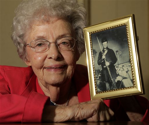 Juanita Tudor Lowrey, age 86, poses with a photo of her father, Civil War veteran Hugh Tudor, on Tuesday in Kearney, Mo. Lowrey received pension benefits related to her father's Civil War service until she was 18, after her father died when she was 2 years old.