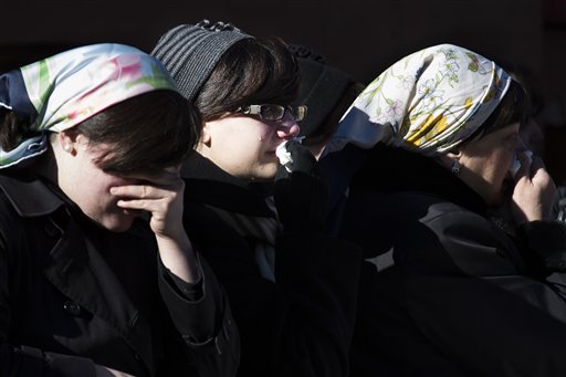 Members of the Satmar Orthodox Jewish community grieve at the funeral of two expectant parents who were killed in a car accident, on Sunday, in the Brooklyn borough of New York. A driver struck the car early Sunday morning, killing both parents while their baby, who was born prematurely, survived and is in critical condition.