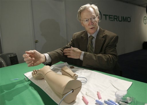Atlanta cardiologist Dr. Spencer King demonstrates how doctors can open blocked heart arteries by going through an arm, using a model, at the American College of Cardiology conference in San Francisco recently.