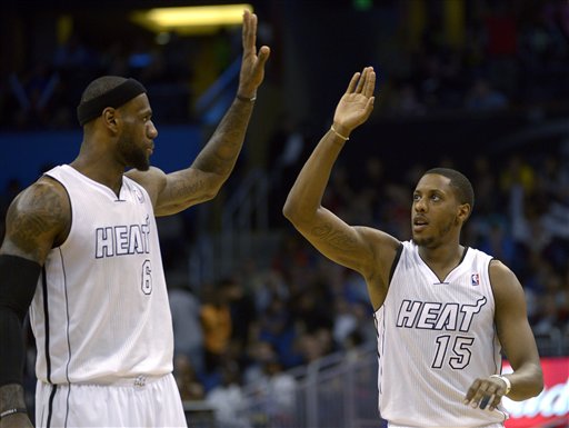 Miami Heat guard Mario Chalmers (15) is congratulated LeBron James (6) during the second half of an NBA basketball game against the Orlando Magic on Monday in Orlando, Fla. The Heat won 108-94 to stretch their winning streak to 27 games.