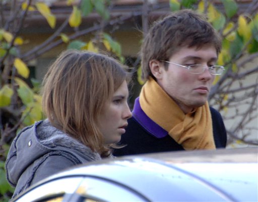In this Nov. 2, 2007, photo, Amanda Marie Knox, left, and her then-boyfriend Raffaele Sollecito are shown outside the rented house where 21-year-old British student Meredith Kercher was found dead in Perugia, Italy.