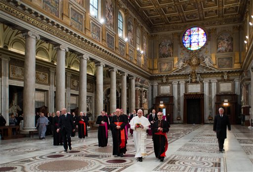 In this photo provided by the Vatican newspaper L'Osservatore Romano, Pope Francis, center, flanked at left by Cardinal Agostino Vallino, and at right by Cardinal Santos Abril y Castello, walks inside St. Mary Major Basilica, in Rome on Thursday. Pope Francis prayed at Rome's main basilica dedicated to the Virgin Mary a day after cardinals elected him the 26th pope.