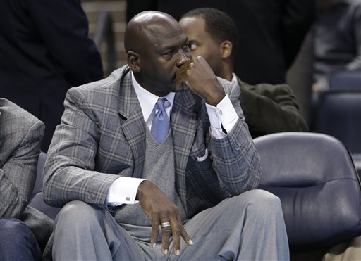 Charlotte Bobcats owner Michael Jordan looks on from courtside during an NBA basketball in this Jan. 23, 2013, photo. He says the paternity suit against him is a "shameless, bad faith attempt to abuse the legal system."