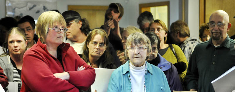 END OF TERM: Ann Chadwick, center in blue, says she was terminated as town clerk Wednesday March 6, 2013 in Pittston by the selectmen.