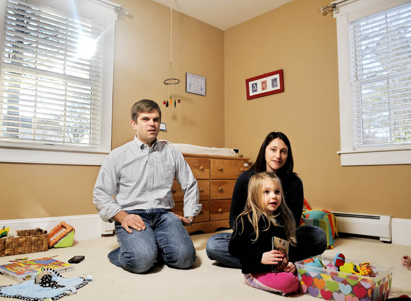 Ethan and Emily Bessey, with their daughter, Daisy, discuss the brief life of their son, Ezra, in the boy's bedroom at their Hallowell home. The infant died of spinal muscular atrophy in early February.