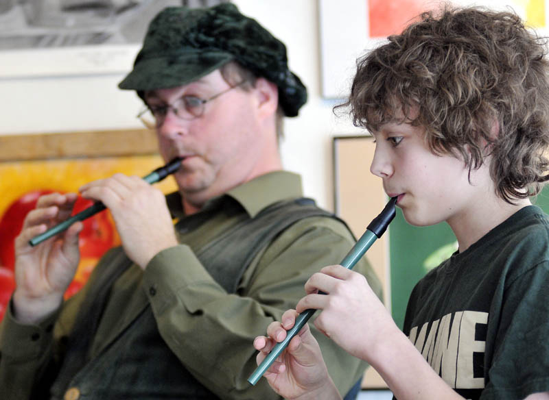 Adam Soosman, left, and Will Fahy, 13, play tin whistles Sunday at the Harlow Gallery in Hallowell. The duo played traditional Irish songs on the instruments during a fundraiser at the gallery on Saint Patrick's Day.