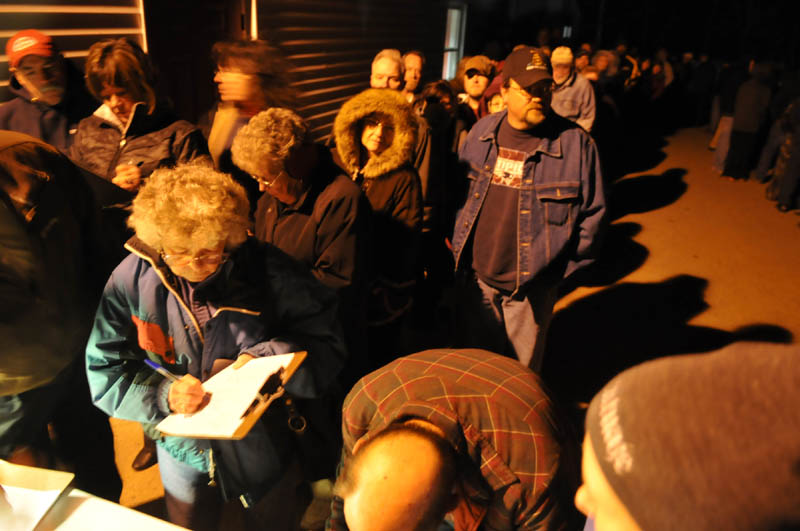 Pittston residents line up in the cold Thursday evening to sign petitions to recall selectmen following the termination of Ann Chadwick, 75, from town positions.