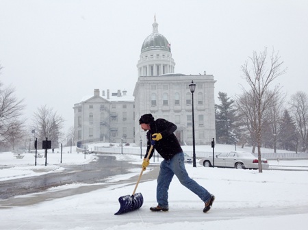 Tim Campbell shovels snow at the State House complex on Tuesday in Augusta. He was part of the Bureau of General Services crew clearing sidewalks and lots.