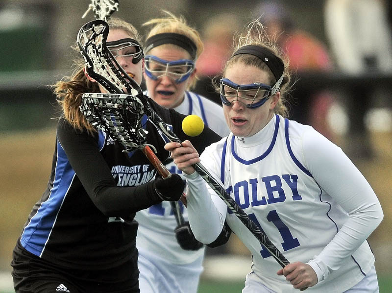 STICK WORK: University of New England’s Cassidy Ruocco,left, and Colby’s Abby Hatch battle for the ball in the first period Saturday at Colby College in Waterville. The Mules won 18-0.
