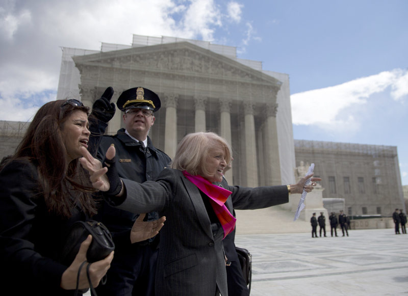 Plaintiff Edith Windsor of New York waves to supporters in front of the Supreme Court in Washington, Wednesday, after the court heard arguments on the Defense of Marriage Act (DOMA) case.