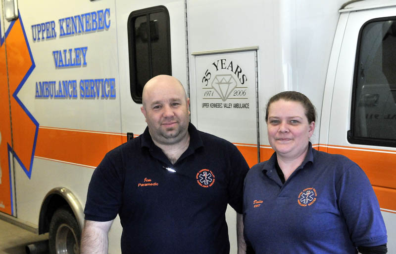 James Baldwin, a paramedic, and Doraine "Dodie" Mathieu, an emergency medical technician, both with the Upper Kennebec Valley Ambulance Service, stand next to an ambulance at the service's Bingham office Friday.