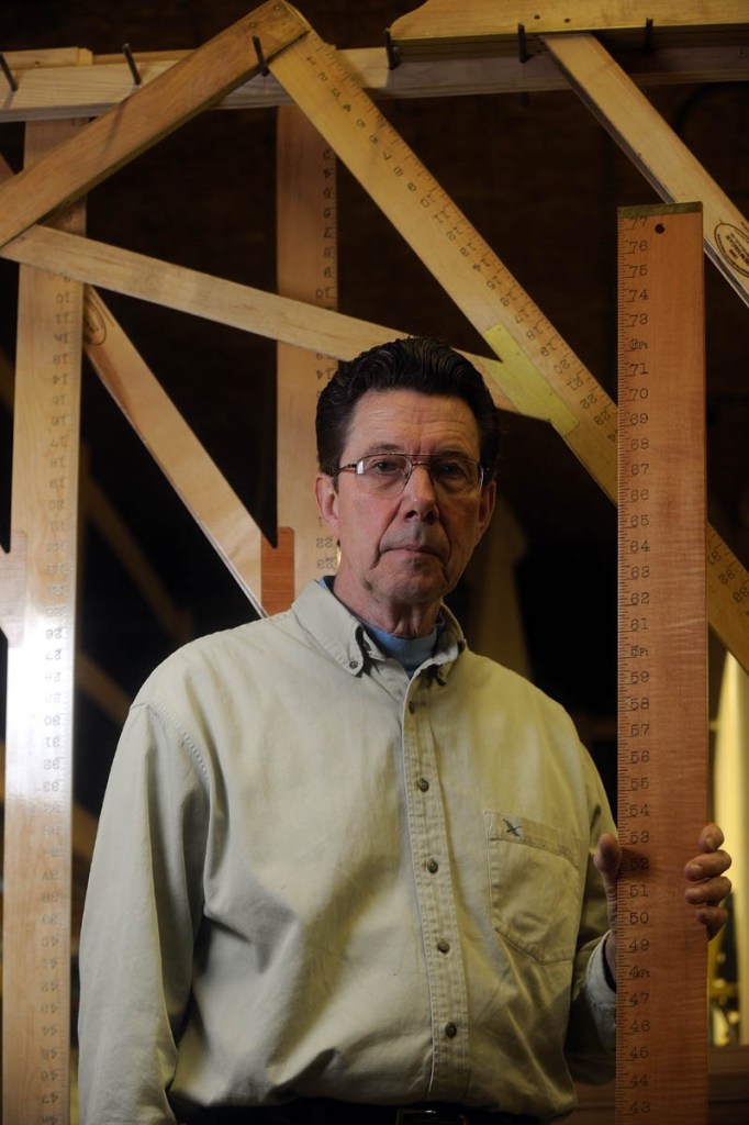 Steve Meisner, owner of Wooden Rule, Co., stands with a height measuring ruler, with one-of-a-kind L-squares that are made exclusively by Wooden Rule, Co., in East Madison.
