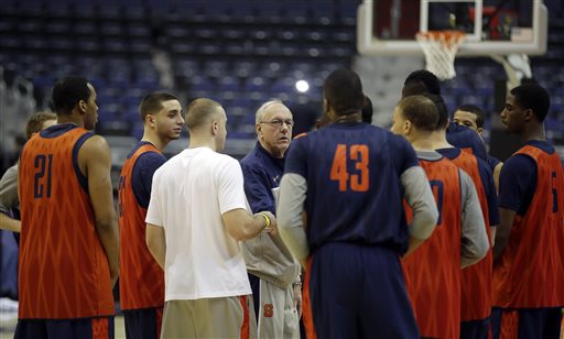 Syracuse head coach Jim Boeheim, center, talks with his players at the end of practice for a regional semifinal game in the NCAA college basketball tournament, Wednesday, March 27, 2013, in Washington. Syracuse plays Indiana on Thursday. (AP Photo/Pablo Martinez Monsivais)