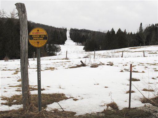 In this March 11 photo, a sign indicates a section of a buried crude oil pipeline in Burke, Vt. Canadian energy officials insist they have no plans to reverse the flow of the pipeline that now carries crude oil from Maine to Montreal, but that has done little to reassure New England towns that are against the idea and the 18 members of Congress asking for a full environmental review.