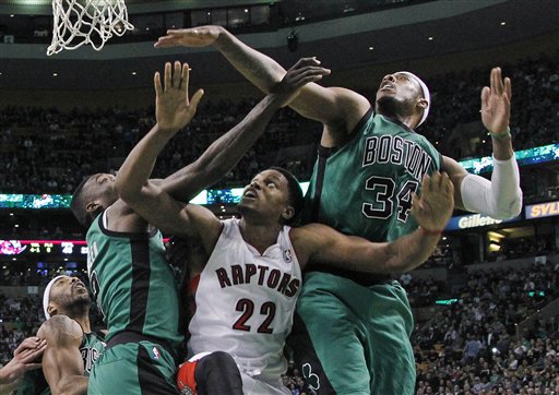 Toronto Raptors forward Rudy Gay (22) fights for position under the basket between Boston Celtics forwards Paul Pierce (34) and Jeff Green, left, during the second half of an NBA basketball game against the Toronto Raptors in Boston, Wednesday, March 13, 2013. The Celtics won 112-88. (AP Photo/Elise Amendola)