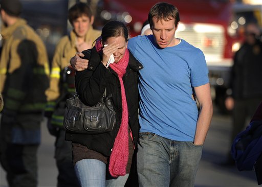 In this Dec. 14, 2012, photo, Alissa Parker, left, and her husband, Robbie Parker, leave the firehouse staging area after receiving word that their 6-year-old daughter Emilie was one of the 20 children killed in the Sandy Hook School shooting in Newtown, Conn.