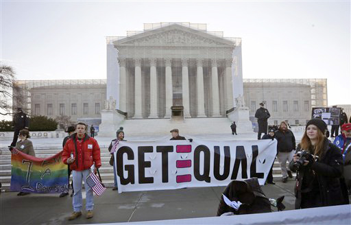 Demonstrators stand outside the Supreme Court in Washington on Tuesday.