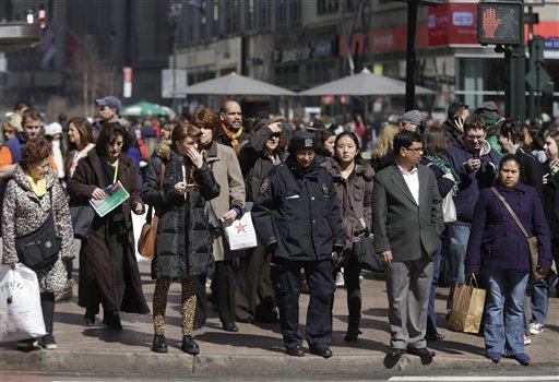 In this photo taken Wednesday, pedestrians wait to cross a New York street. An historic decline in the number of U.S. whites and the fast growth of Latinos are blurring traditional black-white color lines in the U.S. The demographic shift is now a potent backdrop to an immigration overhaul bill, being debated in Congress, that could offer a path to citizenship for 11 million mostly Hispanic illegal immigrants.