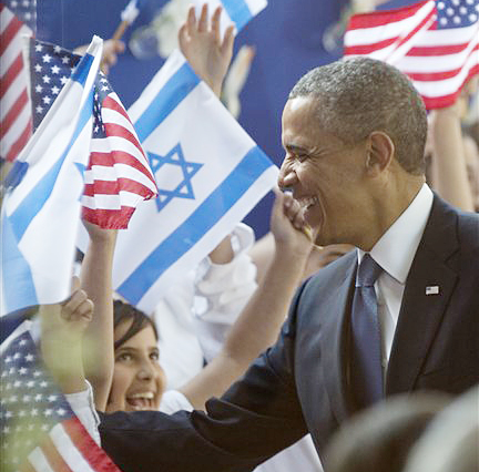 President Obama is greeted by children waving Israeli and American flags as he arrives at the residence of Israeli President Shimon Peres on Wednesday in Jerusalem.