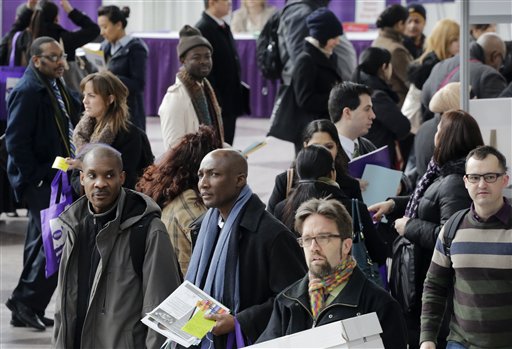 Job seekers attend a health care job fair on Thursday in New York. Fewer layoffs are strengthening the job market.