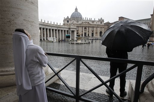 A nun watches the rain in St. Peter's Square during the second day of the conclave to elect a new pope at the Vatican on Wednesday.