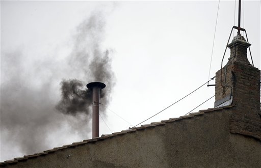 Black smoke emerges from the chimney on the roof of the Sistine Chapel on Wednesday, iindicating that the new pope has not been elected yet.