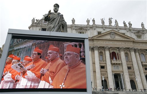 A giant monitor in St. Peter's Square at the Vatican, shows cardinals praying on Tuesday. Cardinals have begun the conclave to elect the next pope amid deep divisions and uncertainty over who will lead the 1.2 billion-strong Catholic church and tend to its many problems.
