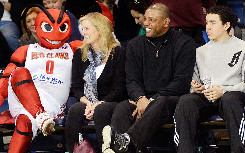 Red Claws mascot Crusher finds an open seat during Sunday’s game next to the Rivers clan – Doc, center, with his wife, Kristen, and their youngest son, Spencer.