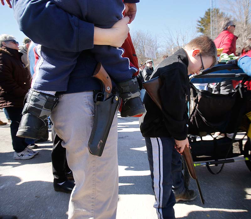 File photo: Suzanne Hiltz of Chelsea holds her son, Samson, with a Ruger Single-Six .22 caliber revolver on her hip, while attending a 2014 rally in Wiscasset protesting gun control legislation and supporting gun rights. At right is Hiltz's son Jonah, holding a .22 caliber youth model rifle.