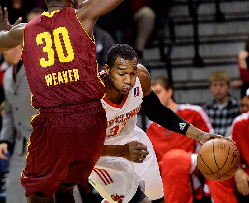 Maine's Chris Wright drives around Kyle Weaver of the Canton Charge Sunday at the Porland Expo. The Claws lost, 108-83.