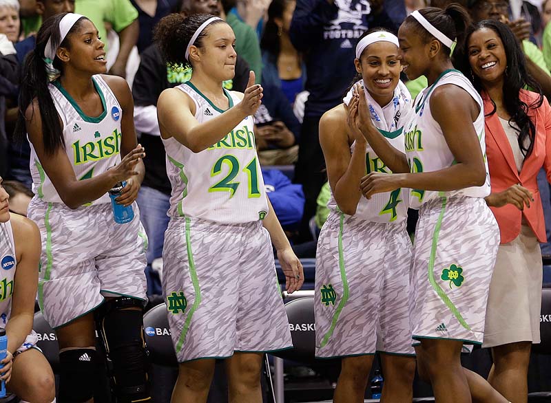 Notre Dame's Jewell Loyd, right is welcomed to the bench by teammates Skylar Diggins, second from right, Kayla McBride, 21, and Ariel Braker during the second half of Sunday's regional semifinal in the NCAA women's basketball tourney at Norfolk, Va. Notre Dame beat Kansas 93-63.