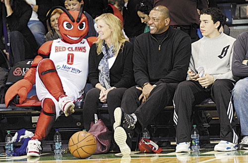 FAMILY TIME: Boston Celtics coach Doc Rivers, his wife Kristen, left, and youngest son Spencer, right were at the Portland Expo to watch his son, Jeremiah, play with Red Claws when Crusher sat beside the family during a break in the action Sunday.