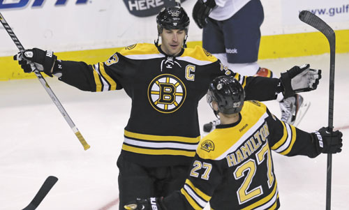 THAT’S A GOAL: Boston Bruins defenseman Zdeno Chara is congratulated by teammate Dougie Hamilton (27) after his goal against the Florida Panthers during the first period Thursday in Boston.