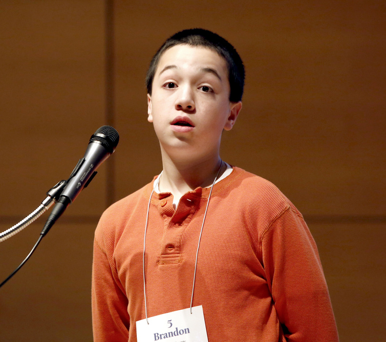 Brandon Aponte, 12, representing Hancock County, reacts after being told he spelled the word "crambo" correctly to win the Maine State Spelling Bee at the Hannaford Lecture Hall at the USM Portland campus on Saturday.