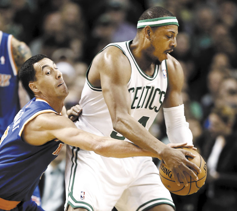 BEHIND YOU: New York’s Pablo Prigioni, left, tries to steal the ball from Boston’s Paul Pierce during the first quarter of their game Tuesday in Boston.