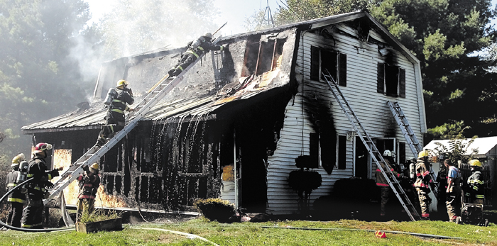 Firefighters from several departments extinguish fire that destroyed the Turner home on the Libby Hill Road in Palmyra in 2007.