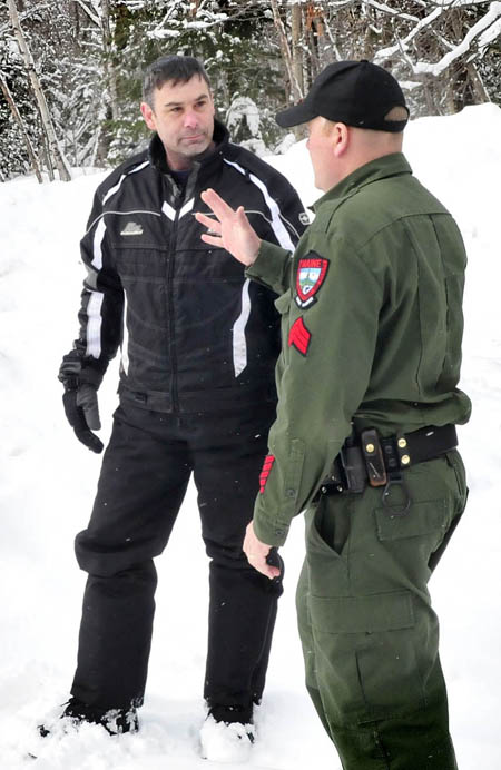 Joseph Paul of Massachusetts speaks with a game warden after bringing missing skier Nicholas Joy out from the Caribou Pond trail near Sugarloaf on Tuesday.