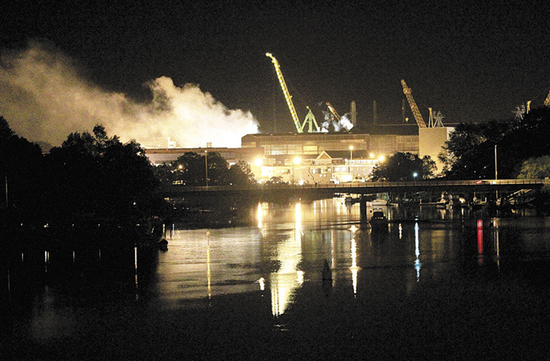 Smoke rises from a Portsmouth Naval Shipyard dry dock as fire crews respond Wednesday, May 23, 2012, to a fire on the USS Miami SSN 755 submarine at the Portsmouth Naval Shipyard on an island in Kittery, N.H. Four people were injured.