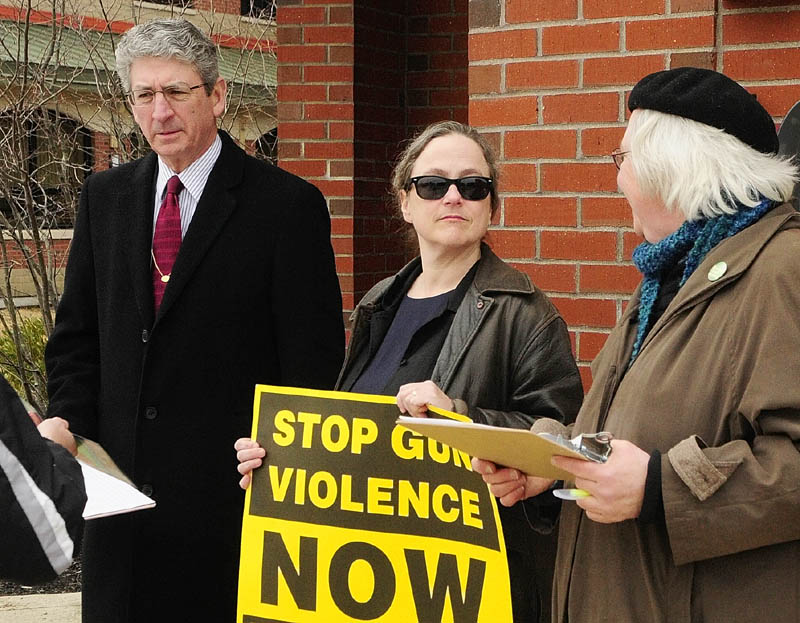 Augusta Mayor William Stokes, left, Deb Fahy, of Hallowell, and Leslie Manning, of the Maine Council of Churches, stand outside the Randall Student Center on Thursday at the University of Maine at Augusta.