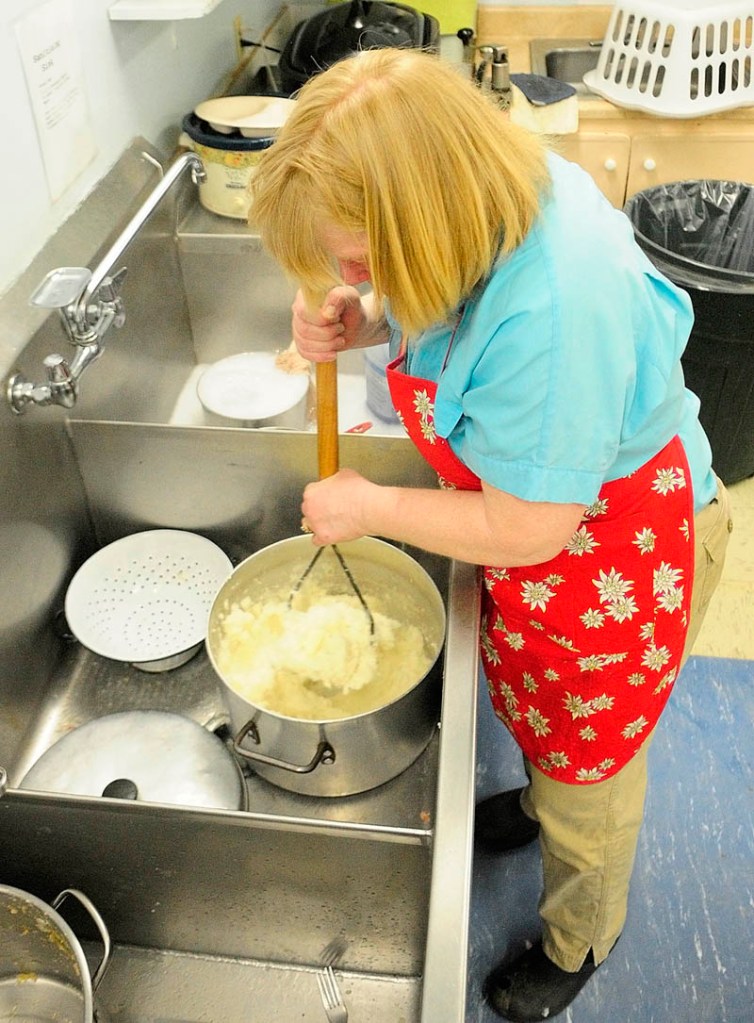 Ann Bako mashes potatoes on Saturday at the Palermo Consolidated School. Members of the Branch Mills Grange prepared lunch, turkey with all the trimmings and dessert, served during a break in the annual town meeting. Grange members said that two 32-pound turkeys were donated by Tobey's Market.