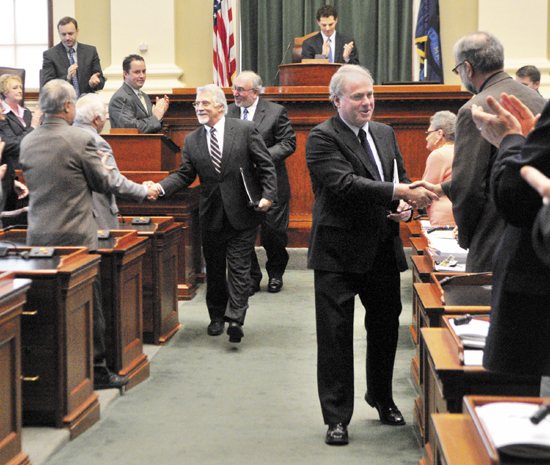 William Brennan, president of Maine Maritime Academy, left, John Fitzsimmons, president of the Maine Community College System, and James Page, chancellor of the University of Maine System, shake hands as they leave the House chamber after giving their State of Education addresses on Thursday at the State House in Augusta.