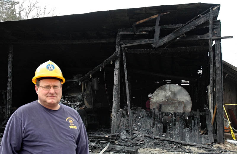 Sgt. Joel Davis of the State Fire Marshal's Office helped investigate the arson fires in Bingham over the weekend. Behind him is the public works garage.