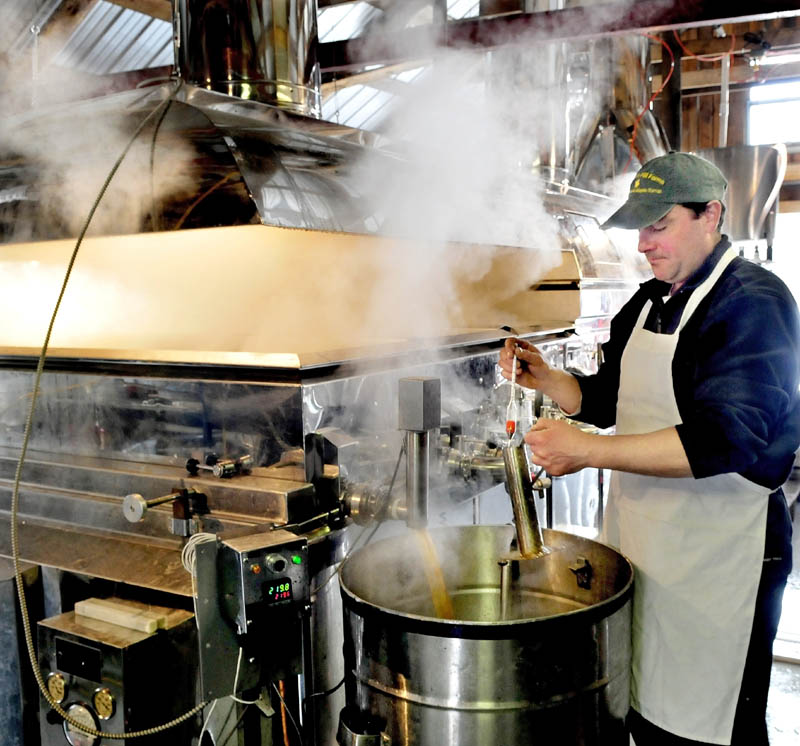 Jeremy Steeves uses a hydrometer to check the sugar density of maple syrup coming out of an evaporator at Strawberry Hill Farm in Skowhegan on March 11. Steeves and his father, Jack, are making syrup for retail and the Sunday's Maine Maple Sunday event.