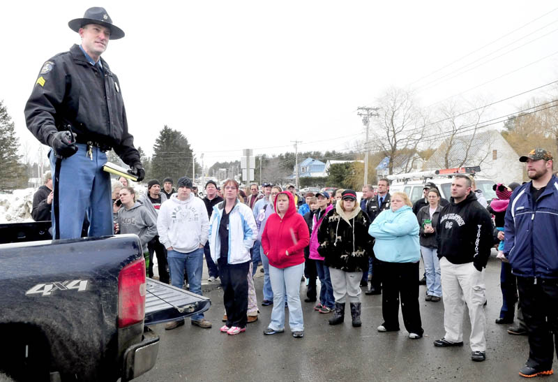 Sgt. Aaron Hayden of the Maine State Police updates parents outside the Mill Stream Elementary School in Norridgewock, regarding the status of a search for a report of a man with a rifle near the school, on Monday. Hayden told the parents that no one was found and they could join their children following the school lockdown.