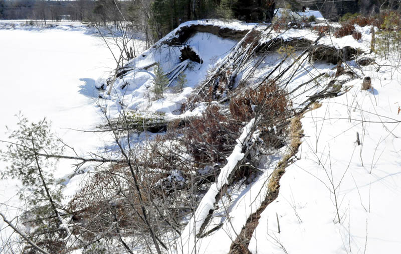 Snow and frozen ground on Thursday have stabilized the eroded bank between the Sandy River and Whittier Road in Farmington, but officials are concerned about the effects warm temperatures and spring rain will have on the riverbank.