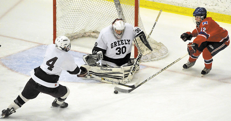 Messalonskee High School's Jared Cunningham, 19, tries to get a shot off on Greely High School goalie Kyle Kramlich, 30, as teammate Miles Shields, 4, tries to defend in the second period of the Class B state championship at the Colisee in Lewiston Saturday.