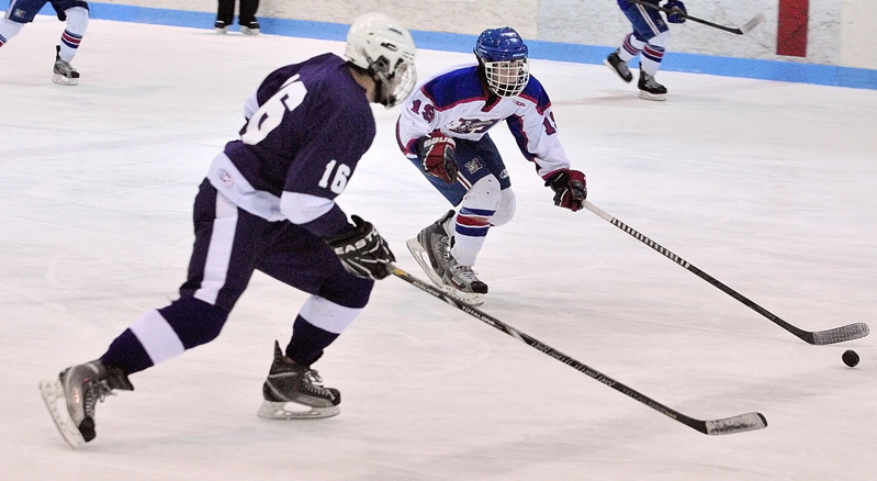 William Manning, left, of Hampden Academy chases Messalonskee’s Jared Cunningham during their Eastern Class B boys’ hockey semifinal Saturday at Sukee Arena. Messalonskee advanced with a 7-5 victory.
