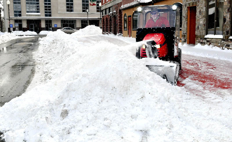 STORM CLEAN UP: Central Maine residents woke up to nearly a foot of snow on Wednesday on the first day of spring. Bruce Heath of KB Property Care clears the outdoor dining area on Silver Street in downtown Waterville.