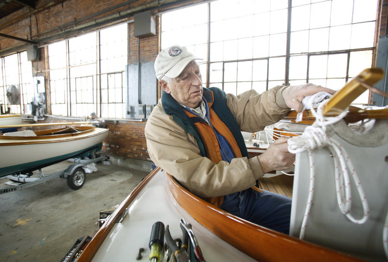 Gordon Goodwin of Cape Cod Shipbuilding Co. begins to rig a Herreshoff H-12 1/2 as exhibitors prepare for the Maine Boatbuilders Show at the Portland Complex in Portland on Thursday afternoon on March 14, 2013.